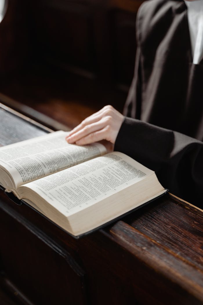 A nun reading a holy book inside a church, embracing spirituality and faith.